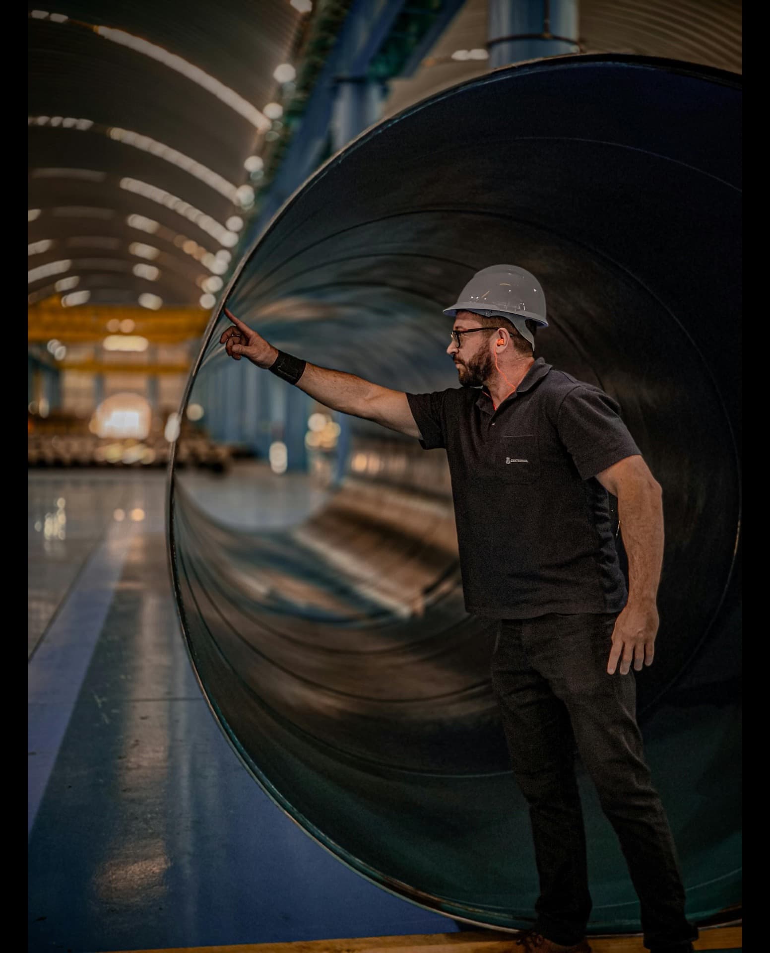 Third-party inspector reviewing pipe spools and tagged material packing list at a fabrication yard